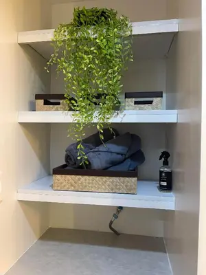 a shelf with a potted plant on it at E & T Homecations 2 Bedroom Apartment at SMDC Air Residences in Manila