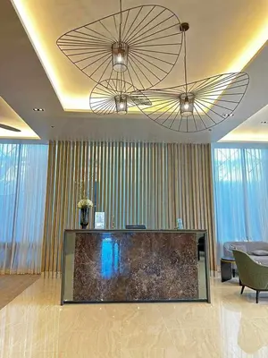 a living room with two chandeliers and a large aquarium at 2BR SMDC Bloom Residences Near NAIA Wi-fi +Netflix in Manila