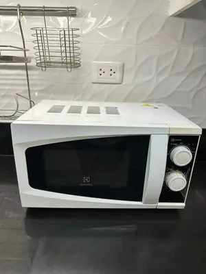 a white microwave sitting on top of a counter at Shell Residences, Pasay near NAIA MOA SMX PICC in Manila