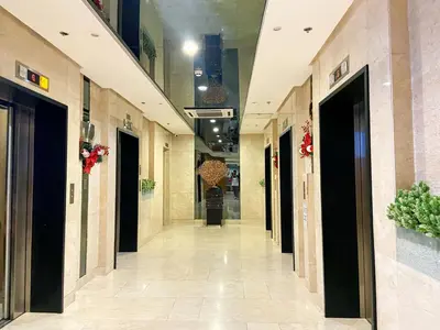 a hallway of a building with many doors at Shore2 Luxurious & Homely Suite near MOA in Manila
