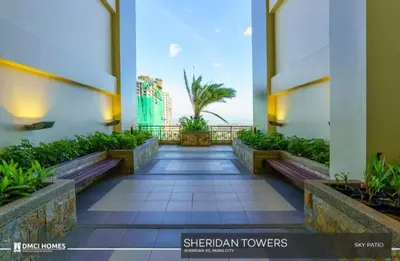 a walkway in a building with a view of the ocean at Condo in Manila
