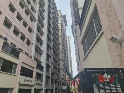 a street with tall buildings and a christmas wreath at 1 Bedroom Condo In Little Baguio Terraces, San Juan City in Manila