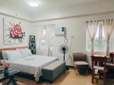 a bedroom with a bed and a desk and chairs at Happy Stays B - 300mbps - 65