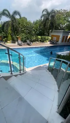 a view of a swimming pool with palm trees at 2-Bed Apartment in Near Airport Paranaque in Manila