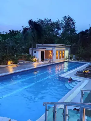 a large swimming pool with a building in the background at 2-Bed Apartment in Near Airport Paranaque in Manila