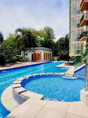 a large swimming pool next to a building at 2-Bed Apartment in Near Airport Paranaque in Manila