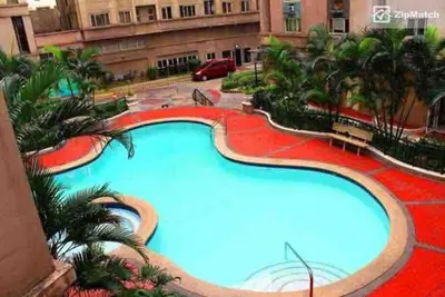 a large swimming pool in the middle of a building at Renovated 2br 2tb Wifi/Netflix very near Mall QC in Manila