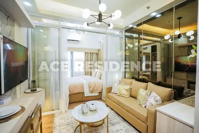 a living room with a couch and a bed at Air Residences Makati with Sunset View in Manila