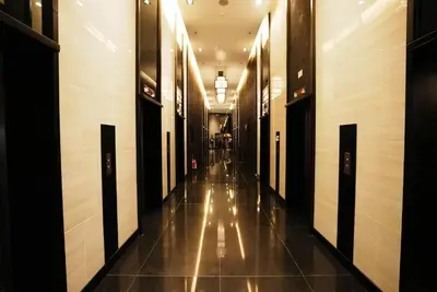 an empty hallway in a building with lights on at Air Residences Makati with Sunset View in Manila