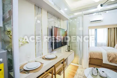 a bedroom with a dressing table and a bed at Air Residences Makati with Sunset View in Manila