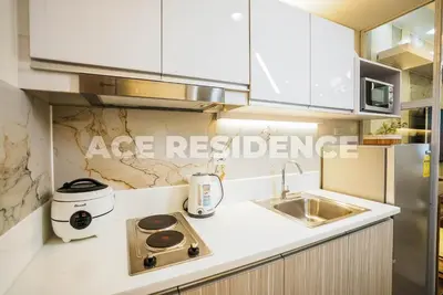 a kitchen with a sink and a counter top at Air Residences Makati with Sunset View in Manila