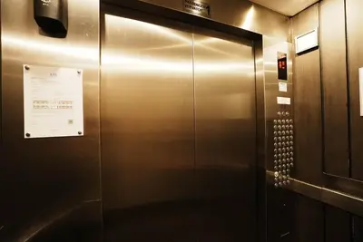 an elevator in a building with a sign on it at Air Residences Makati with Sunset View in Manila