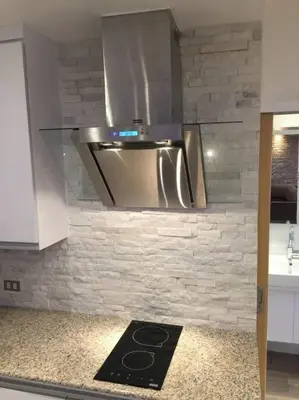 a kitchen with a stainless steel stove top oven at Cozy60sqm 1BR balcony/prking/Wifi/Ntflix near Mall in Manila