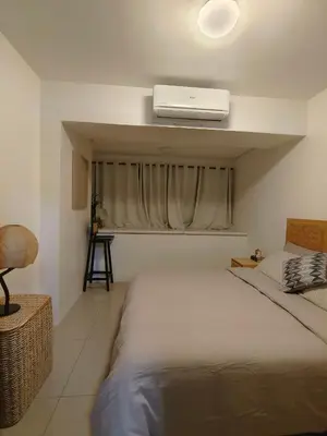 a bedroom with a bed with a air conditioner on the ceiling at METRO STAYCATION PASAY MALL OF ASIA in Manila