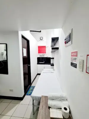 a hospital room with a bed and a bathroom at Dasma Lofts Hotel near Dela Salle Dasma in Dasmariñas