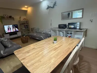 a living room with a wooden table in a living room at SHAW BLVD 69 sqm 2 bdrm w/ WiFi, parking, across Shangrila Mall in Manila