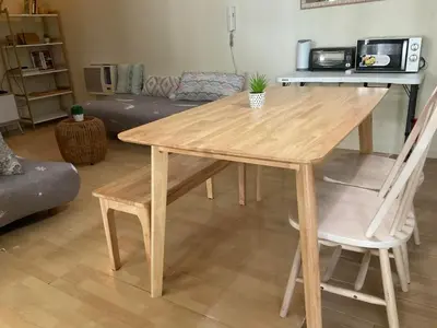 a wooden table and two chairs in a living room at SHAW BLVD 69 sqm 2 bdrm w/ WiFi, parking, across Shangrila Mall in Manila