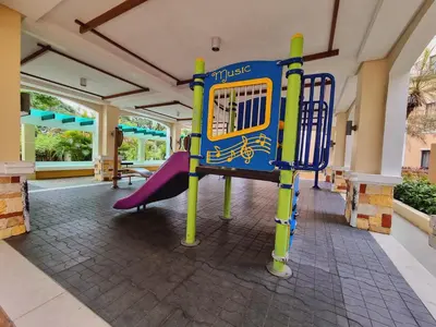 a playground in a building with a purple slide at Modern Minimalist Condo near Airport in Manila