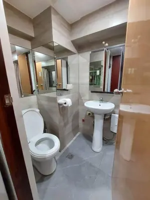a bathroom with a toilet and a sink at 2BR Loft unit in Manila