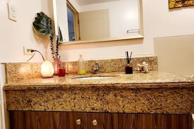 a bathroom counter with a sink and a mirror at Casa Antonio at Fairway Terraces Family Penthouse 2BR Wi-Fi Nr Golf, Airport, Fort BGC in Manila