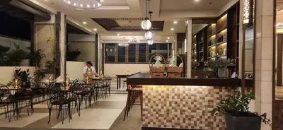 a restaurant with a bar and tables and chairs at Casa Antonio at Fairway Terraces Family Penthouse 2BR Wi-Fi Nr Golf, Airport, Fort BGC in Manila