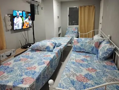 two beds in a hospital room with a tv at 9 Guest - Unit 1 House Type in Pasong Mannga