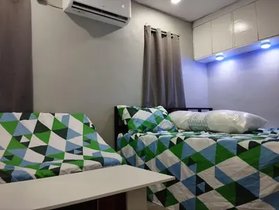 a living room with a couch and a bed at 9 Guest - Unit 1 House Type in Pasong Mannga