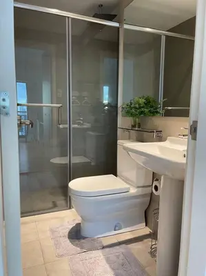 a bathroom with a toilet and a sink and a shower at Aveline Suites Aesthetic Skydeck View ACQUA Private Residences near Rockwell Makati in Manila