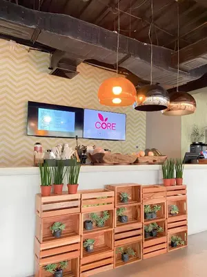 a coffee shop with wooden drawers and potted plants at Aveline Suites Aesthetic Skydeck View ACQUA Private Residences near Rockwell Makati in Manila