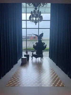 a statue in a room with a large window at Aveline Suites Aesthetic Skydeck View ACQUA Private Residences near Rockwell Makati in Manila