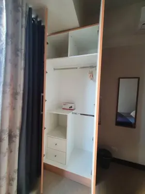 a closet with white shelves and a mirror at Beautiful High End Condo in City Center, Manila in Manila