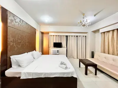 a bedroom with a large bed and a couch at Kiel 4-Star Condo Hotel Near NAIA Manila Airport Terminal in Manila