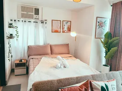 a bedroom with a bed with a stuffed animal on it at Studio Unit Viceroy Residences McKinley Hill BGC in Manila