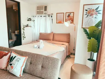 a living room with a bed and a couch at Studio Unit Viceroy Residences McKinley Hill BGC in Manila