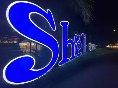 a neon sign that says kiel on the side of a building at Tropical Balcony Pool View, 14th floor, MOA, Netflix, Airport at Shell Residence in Manila
