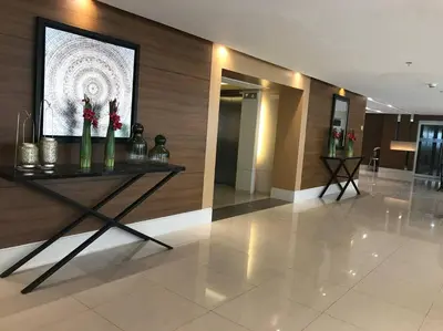 a lobby with a table with flowers on it at Breeze Residences with Ocean view by Bmars in Manila