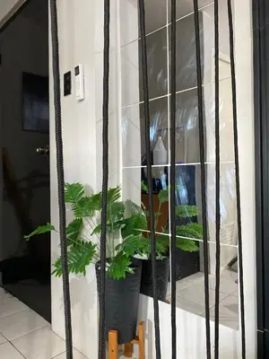 a shelf with potted plants in a room at Casa Cabilao Staycation in Santa Rosa