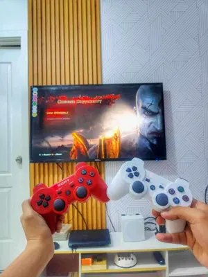 a person holding two video game controllers in front of a tv at Azure resort Paranaque deluxe 8 plus 2toddler free in Manila