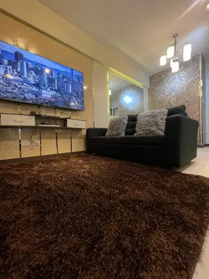 a living room with a couch and a large tv at Two Bedroom Fully Furnished 70sqm CONDO MIREA RESIDENCES PASIG in Manila