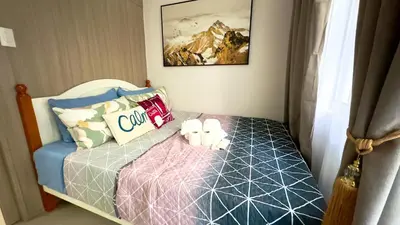 a small room with a bed in a room at ART's Nest at Shore Residences in Manila