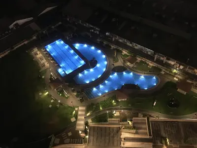 an overhead view of a swimming pool at night at Prisma residence Celeste tower PH 16B with fully furnished and fast wifi for rent in Manila