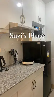 a kitchen with a black refrigerator and a counter top at Suzi's Place @ Green 2 Residences Free Wi-fi & Netflix in Dasmariñas