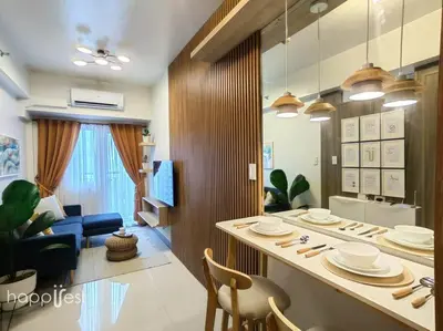 a kitchen and living room with a table and chairs at Happirest at Coast Residences, Pasay - 1 Bedroom with Balcony in Manila