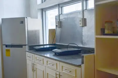 a kitchen with two blue pans on a counter at JP Santiago Studio Makati J206 in Manila