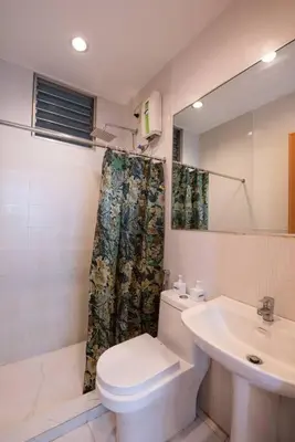 a bathroom with a toilet and a sink at JP Santiago Studio Makati J208 in Manila
