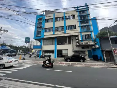 a person riding a scooter in front of a building at JP Santiago Studio Makati J303 in Manila