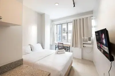 a hotel room with a bed and a television at JP Santiago Studio Makati J308 in Manila