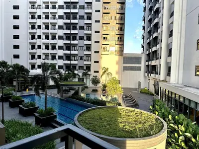 a view from the balcony of a building with a swimming pool at Staycation at Spring Residences in Paranaque in Manila