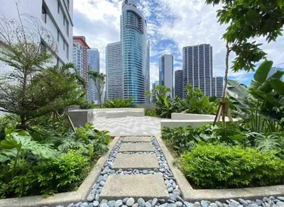 a garden in a city with tall buildings at AIR Luxury Makati CBD with balcony in Manila