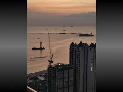 a view of the ocean from a building at 40 Percent Promo Off This Month, Balcony Ocean View Plus Free Pool & Sauna Access Exclusive 2025 Rates at Walking Distance US Embassy, Front of Robinsons Place MANILA, Bellagio and Experience Breathtaking Manila Bay Views in Manila